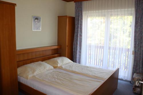 a bedroom with a bed in front of a window at Ferienhaus Drobesch in Sankt Kanzian