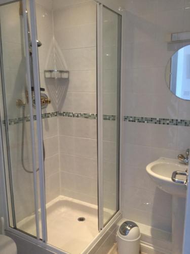 a bathroom with a shower and a sink at Seaside Retreat in St Ives