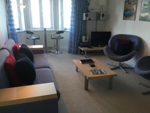 a living room with a couch and a coffee table at Seaside Retreat in St Ives