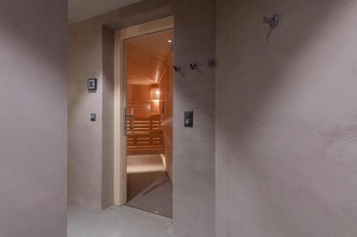 a hallway with a door leading to a dining room at Andermatt Alpine Apartments in Andermatt