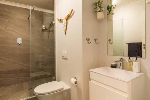 a bathroom with a shower and a toilet and a sink at MONDAINE CENTRAL LUXURIOUS SPACIOUS AND TRENDY in Cape Town