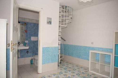 a bathroom with a ladder and a sink and a toilet at Villa Paola sullo scoglio in Anzio