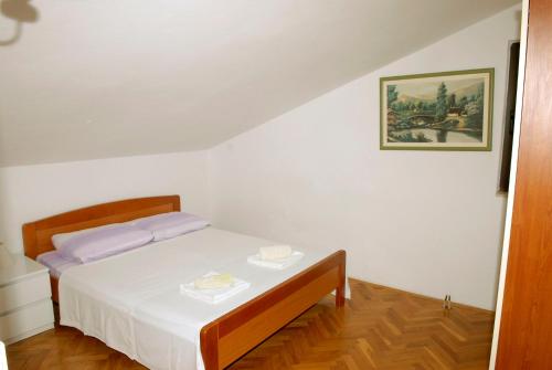 a bedroom with a bed with a table in it at Apartments Villa Tanja in Podstrana