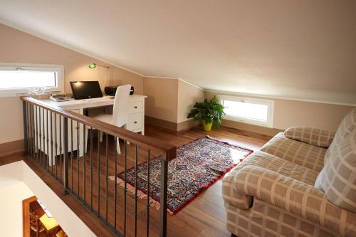 a living room with a couch and a desk with a computer at Holiday home with exclusive swimming pool in the Tuscan Maremma in Montemassi