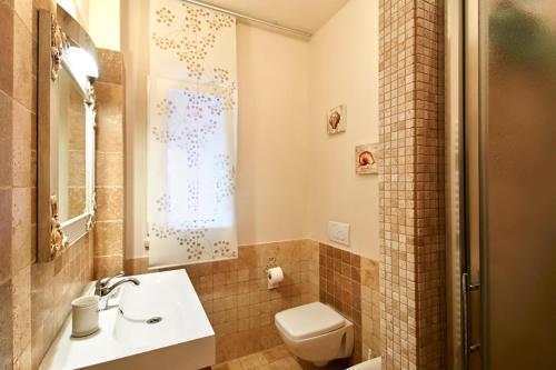 a bathroom with a toilet and a sink at Holiday home with exclusive swimming pool in the Tuscan Maremma in Montemassi