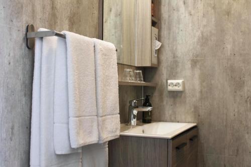 a bathroom with a sink and a towel rack at Vík Cottages in Vík