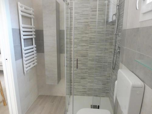 a bathroom with a toilet and a glass shower at Residence Caorle App. n. 5 in Caorle