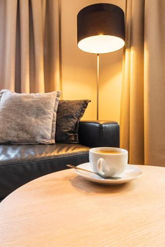 a cup of coffee on a table next to a couch at Chalet Raufthubel in Mürren