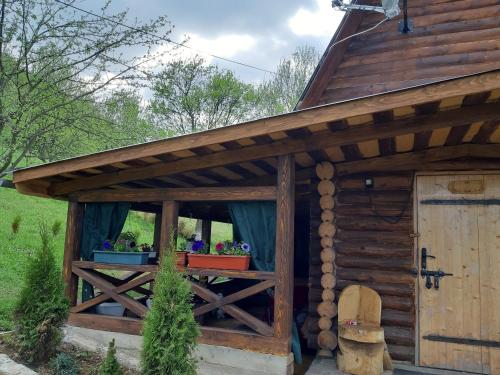 a wooden out house with a window and a door at Дерев'яний будинок з банею in Oriv