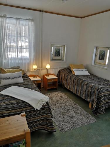 a hotel room with two beds and a window at Apartment Seita in Levi