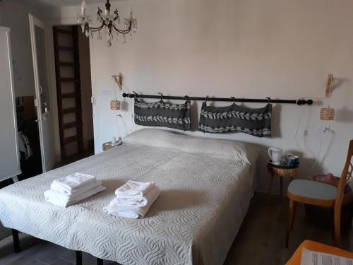 a bedroom with a bed with towels on it at Come una volta in Monte Isola