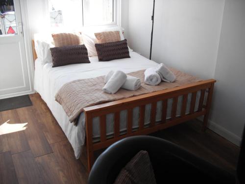 a bedroom with a bed with two towels on it at White Horse Studio in Preston