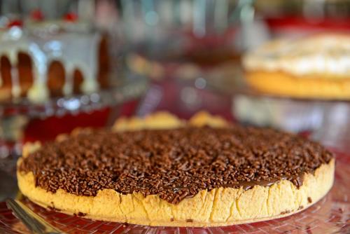 a chocolate cake sitting on top of a cooling rack at Curi Palace Hotel in Pelotas