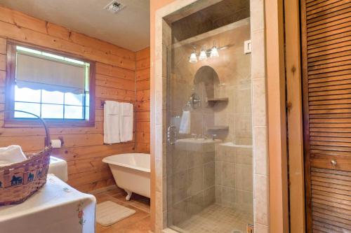 Un baño con ducha, bañera y lavabo. en On Farm Rustic Carmine Log Cabin with Porch!, en Carmine