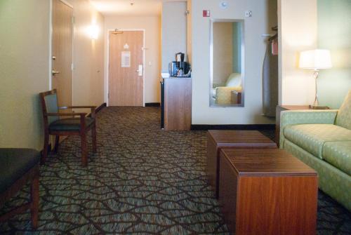 a hotel room with a couch and a table at Holiday Inn Express & Suites Jacksonville South - I-295 by IHG in Jacksonville