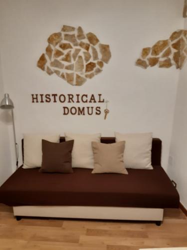 a bed in a room with a sign on the wall at Historical Domus in Anagni