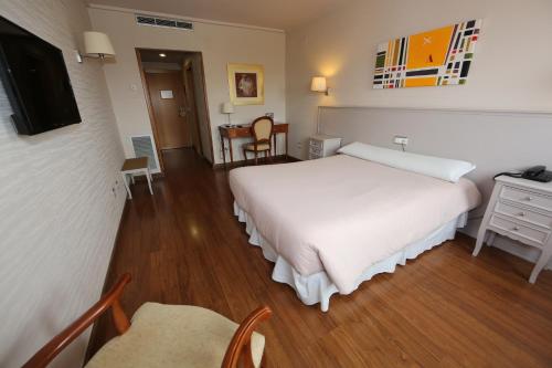 Postel nebo postele na pokoji v ubytování Hotel Universidad