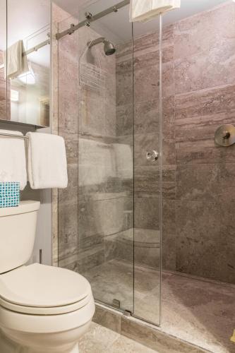 a bathroom with a toilet and a glass shower at Lionshead Arcade by Vail Realty in Vail