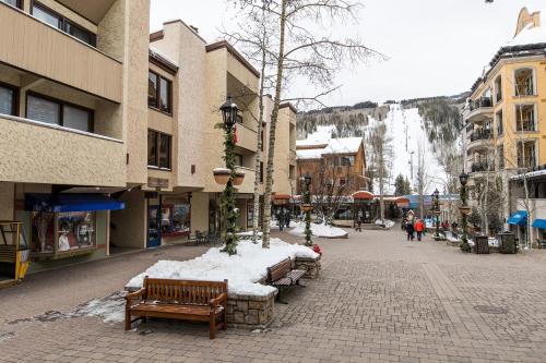 a street in a town with snowcovered benches and buildings at Lionshead Arcade by Vail Realty in Vail