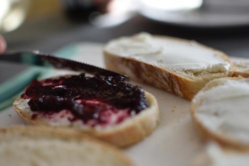 a piece of bread with jam on it with a knife at Curt di Clement Eco Mobility Hotel in Tirano
