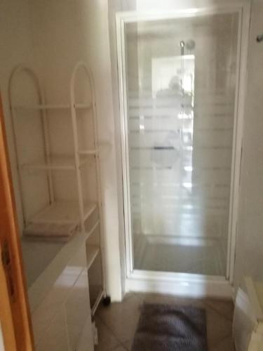 - un dressing avec une porte en verre dans l'établissement Mas Maurane - Le Romarin aux portes d'ARLES, à Tarascon