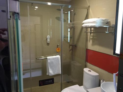 a bathroom with a shower and a toilet and a sink at 7Days Premium Dalian Development Zone Wucaicheng rail station in Dalian