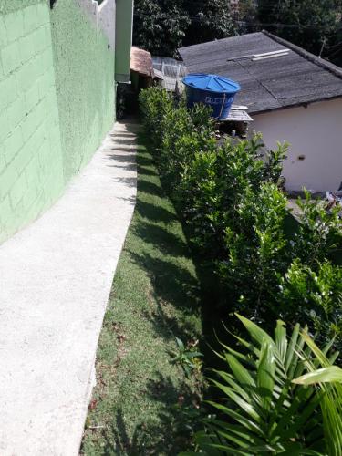 a garden with green bushes next to a building at Magic Island Casas in Florianópolis