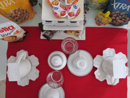 a table topped with white plates and food at B&B Regina Margherita in LʼAquila
