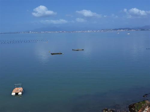 a large body of water with a boat in it at Magic Island Casas in Florianópolis