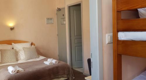 a bedroom with a bed and a bunk bed at Hôtel Terminus in Luz-Saint-Sauveur