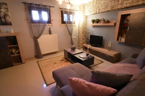 a living room with a couch and a tv at In The Castle - House in Ioannina