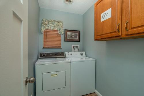 a kitchen with a washing machine in a room at Across from Dollywood w FREE Dollywood ticket, pets ok wfee, arcade, hot tub in Pigeon Forge
