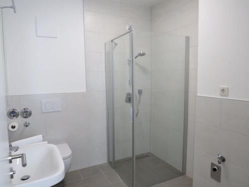 a bathroom with a shower and a toilet and a sink at L8 Street - Q2 16 in Mannheim