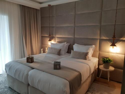 a bedroom with a large bed with a large headboard at The Berg's 3 in Ocna-Mureşului