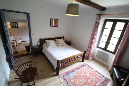 a bedroom with a bed and a mirror at Mas Manyaques in Le Tech