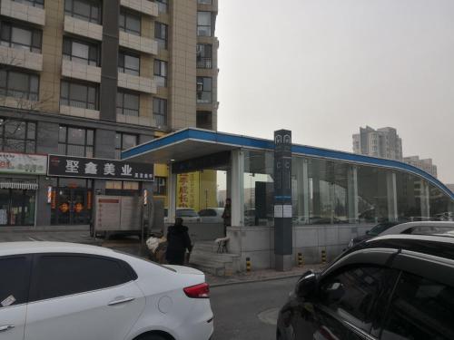 a car parked in front of a bus stop at 7Days Premium Dalian Airport in Dalian