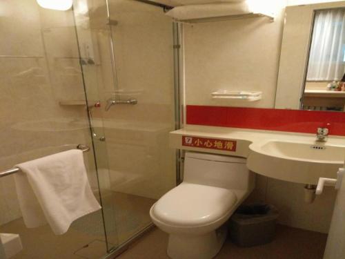 a bathroom with a toilet and a sink and a shower at 7 Days Premium Dalian Zhuanghe Huanghai Avenue in Zhuanghe