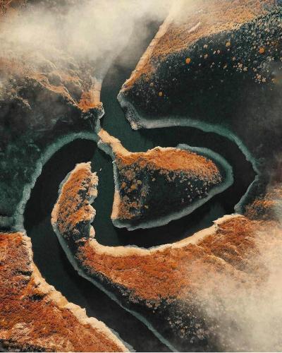 an aerial view of a crater with water in it at Log cabin Uvac (Vikendica Saponjic) in Nova Varoš