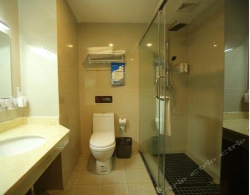 a bathroom with a toilet and a sink and a shower at 7Days Premium Neijiang Wanda Square in Neijiang
