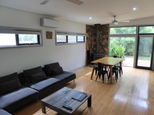 a living room with a couch and a table at Dacelo in Halls Gap