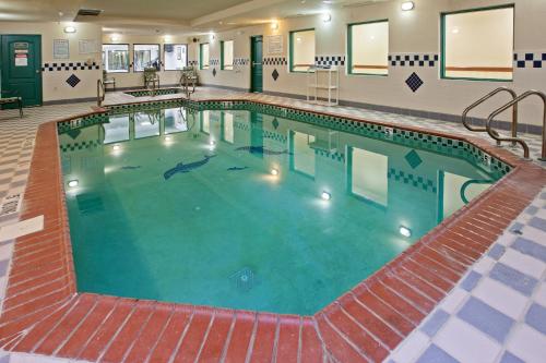 a large swimming pool in a hotel building at Country Inn & Suites by Radisson, Elkhart North, IN in Elkhart