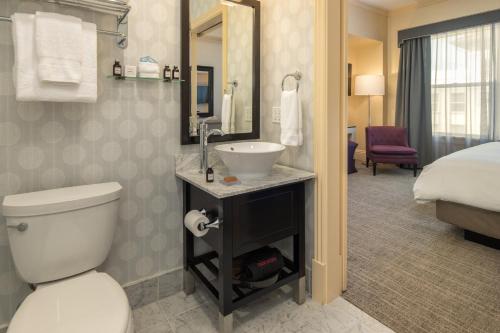 a bathroom with a toilet and a sink and a bed at Hotel Shattuck Plaza in Berkeley