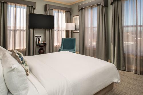a hotel room with a large bed and a chair at Hotel Shattuck Plaza in Berkeley