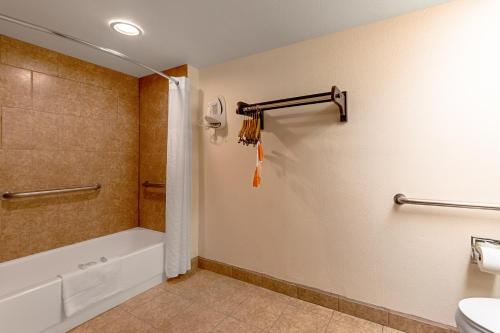 a bathroom with a shower and a toilet and a sink at Quality Inn in Three Rivers