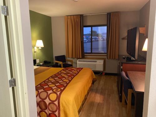 a hotel room with a bed and a window at Super 8 by Wyndham West Memphis in West Memphis