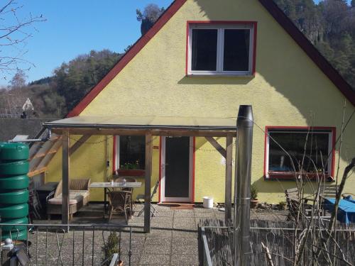 a house with a porch and a patio at Urlaub am Auberg in Gerolstein