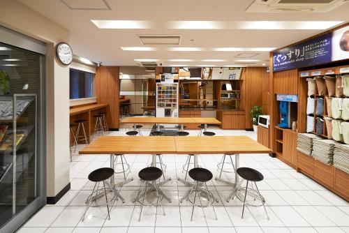 a room with tables and stools in a store at Super Hotel JR Ueno Iriyaguchi in Tokyo