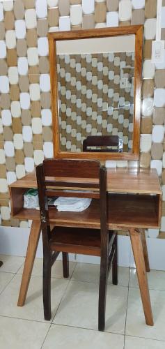 a wooden dressing table with a mirror on it at NHÀ NGHỈ VIỆT NGA in Ha Tien
