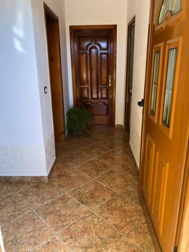 an empty hallway with a door and a tile floor at Guest House MURATI in Durrës