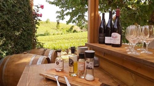 una mesa con botellas de vino y copas de vino en La Maison des Vignes en Charentay